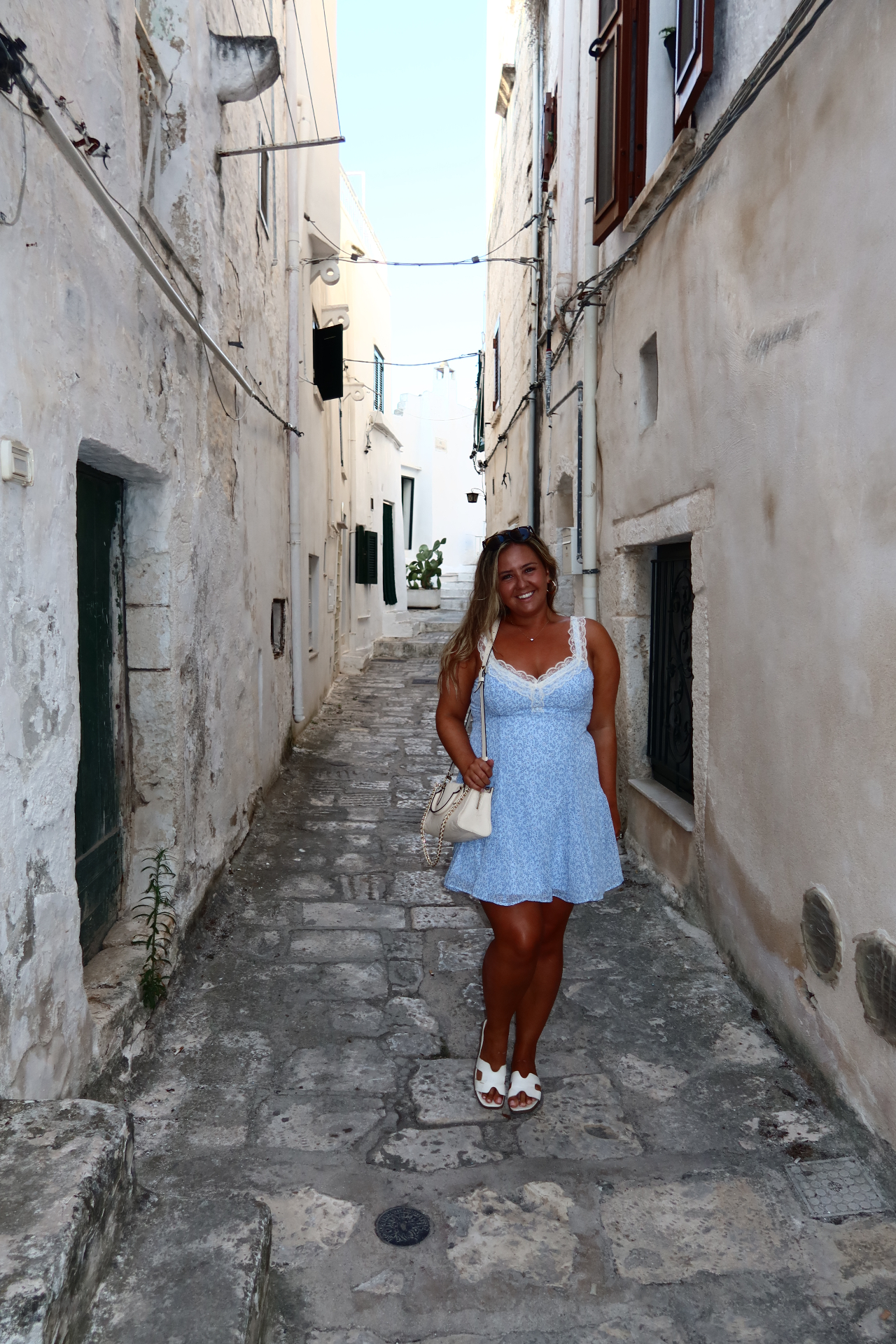 Walking through a white stone alley in Ostuni