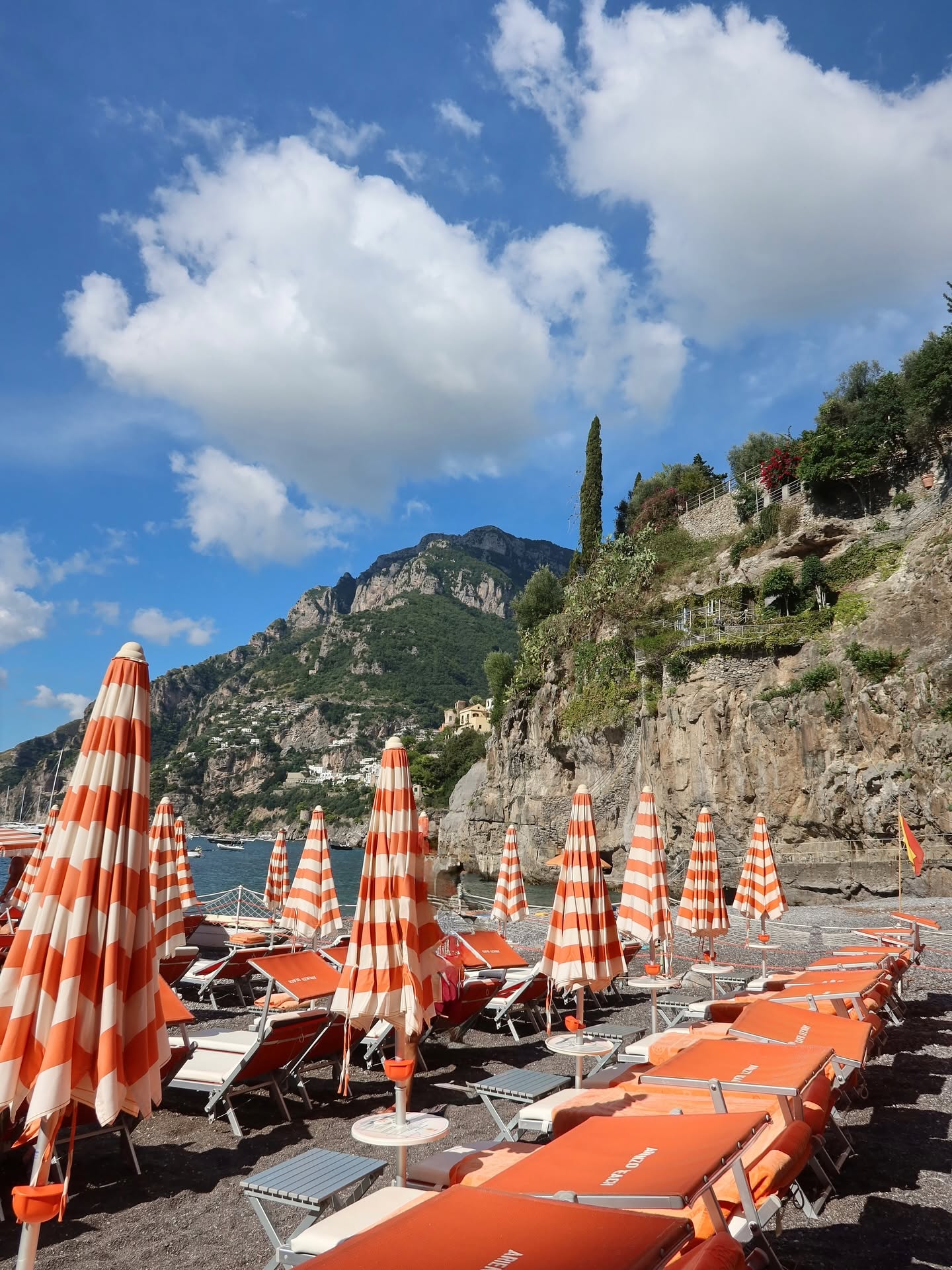 Square: striped umbrellas on the pebbles at Arienzo, Amalfi Coast