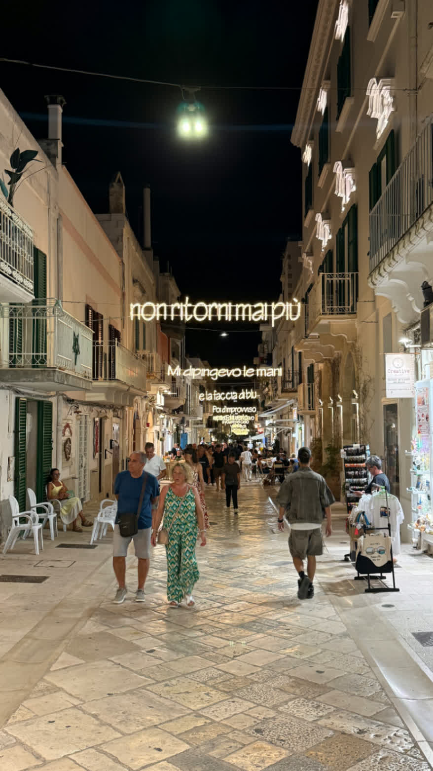 A narrow Puglia street glowing at night