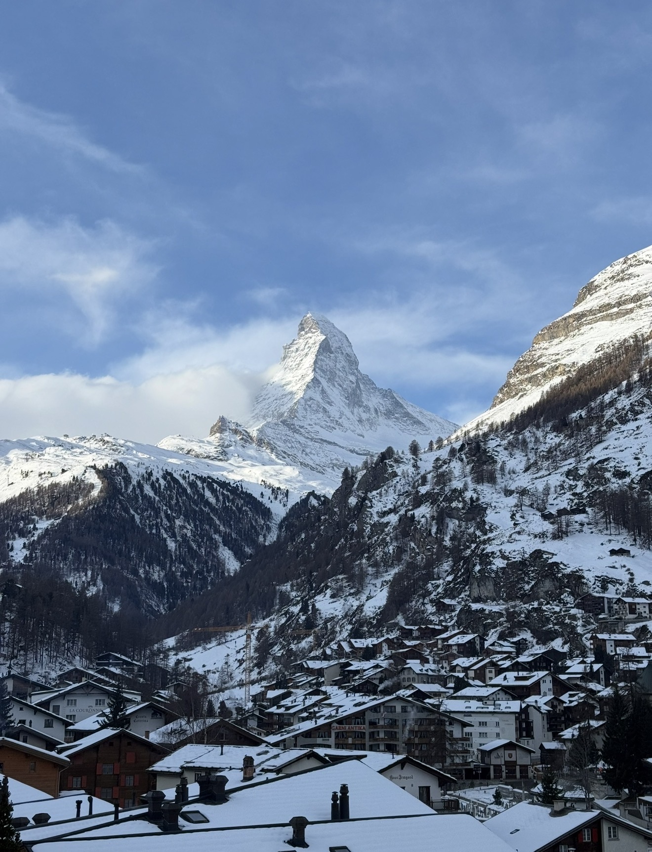 The Matterhorn rising over snow covered Zermatt rooftops, seen from our room